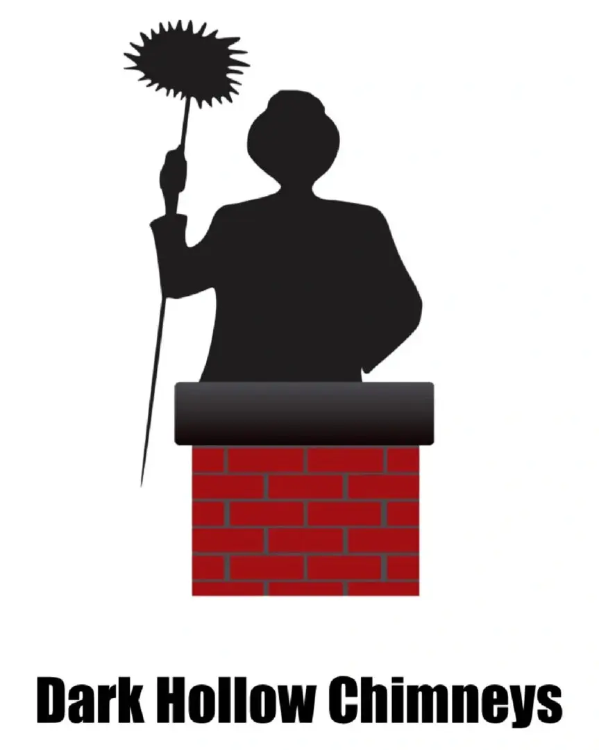 A person holding a broom on top of a brick wall.