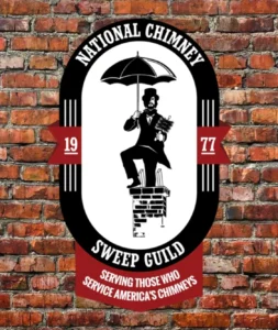A brick wall with the national chimney sweep guild logo.